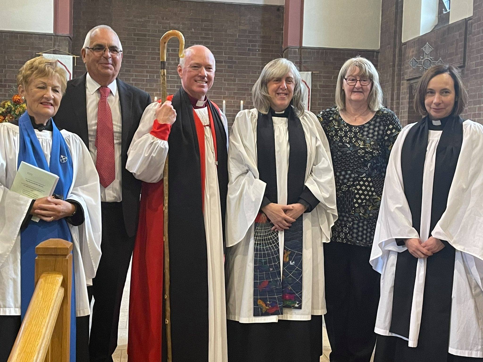 Bishop and and group smiling for photo