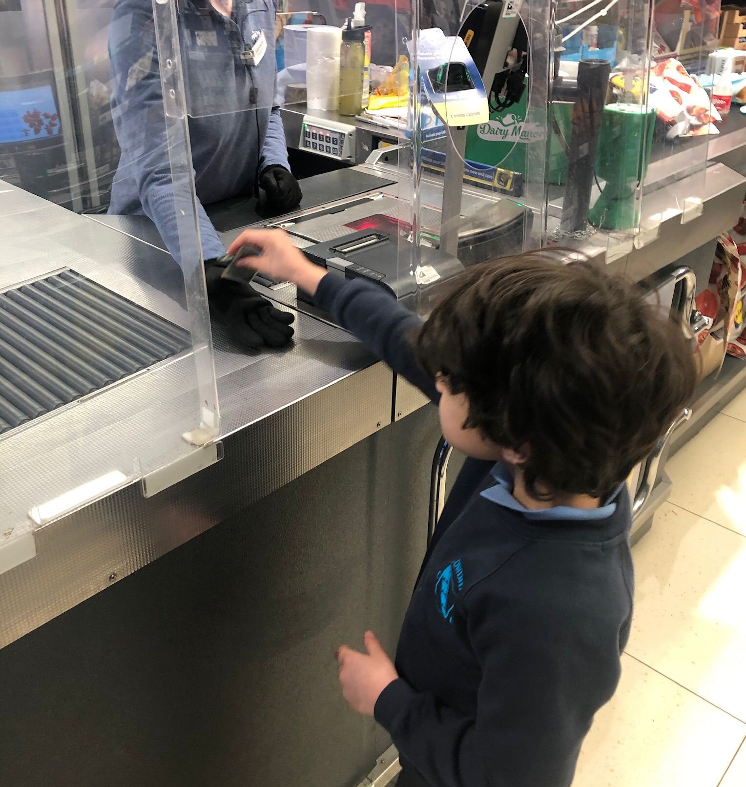 boy paying at till